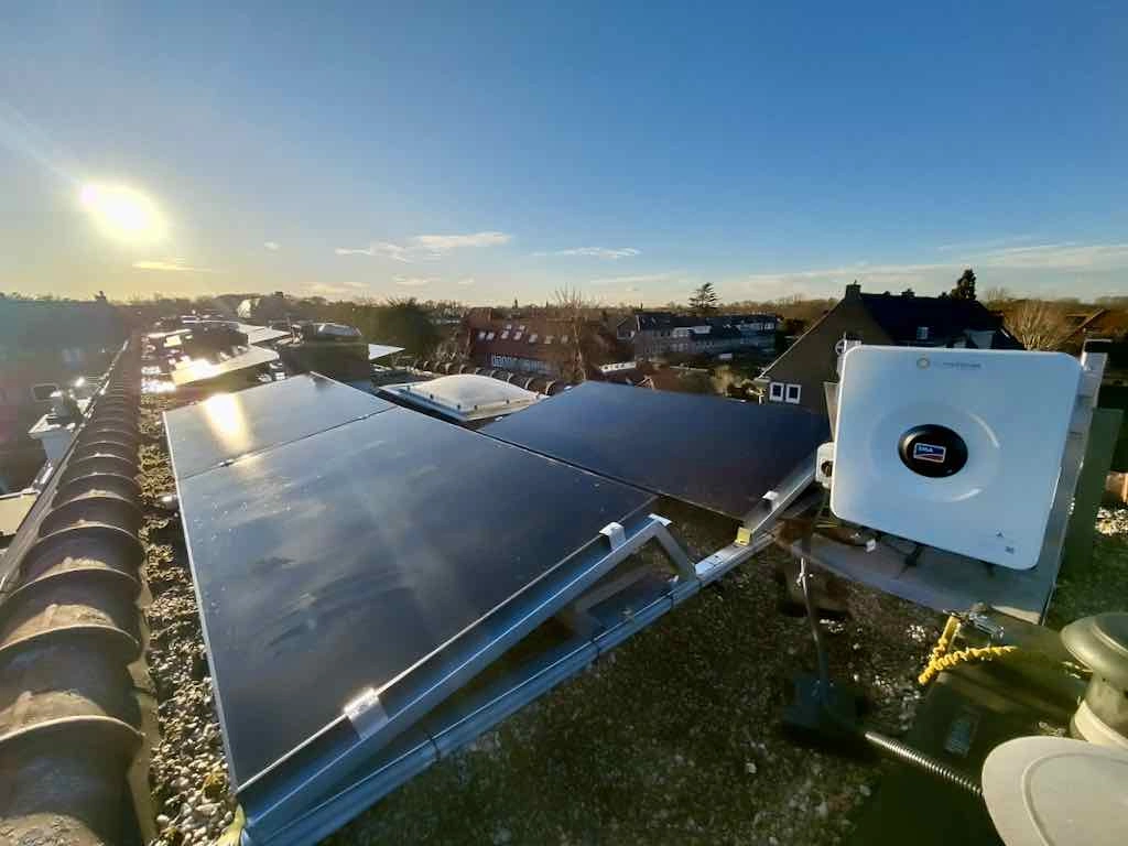 Solar panels and an SMA inverter on a roof in January 2025